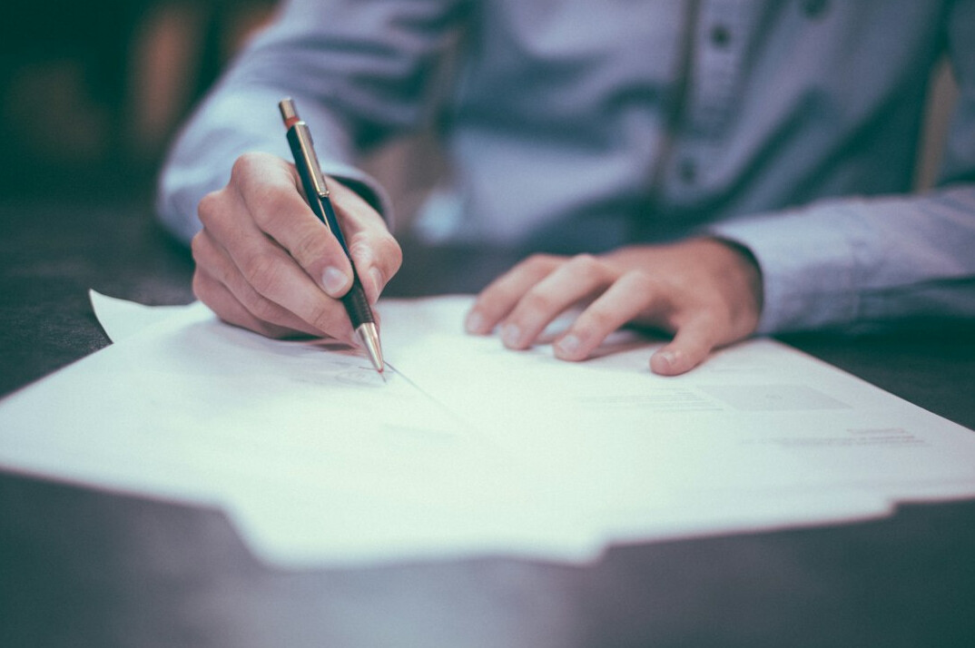 person signing insurance papers
