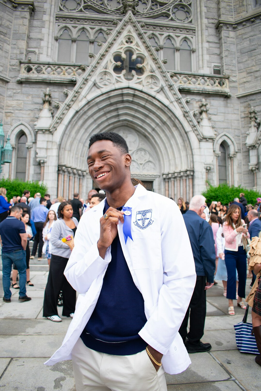 Male doctor in white coat smiling